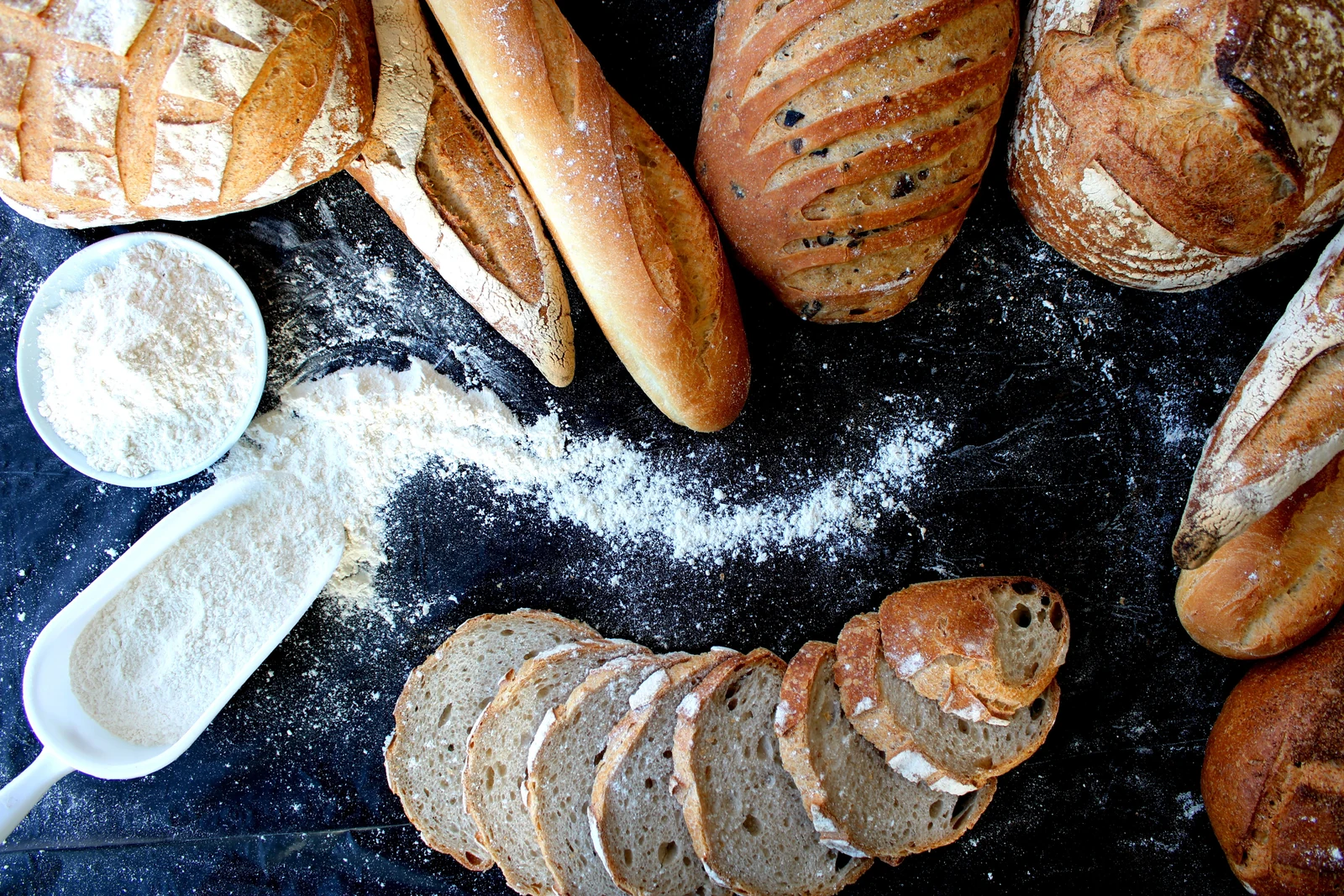 Fresh artisan breads and flour representing Apex Biotech bakery and pastry ingredient solutions